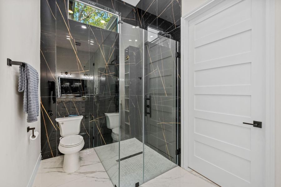 Walk in shower with tile all the way to the ceiling located in between the 3rd and 4th bedroom.