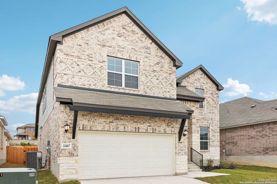 Front exterior of a new home in Sagebrooke - Classic Series, San Antonio, TX, highlighting curb appeal (Image 24). Front exterior of a new home in Sagebrooke - Classic Series, San Antonio, TX, highlighting curb appeal (Image 24).