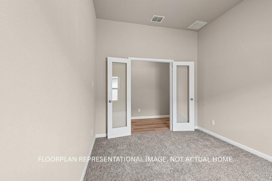 French doors provide a graceful transition between rooms, perfect for a private study or flexible living space.