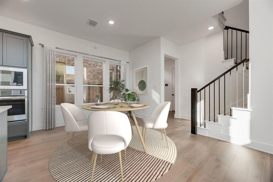 Dining space featuring recessed lighting, light wood-type flooring, and stairway