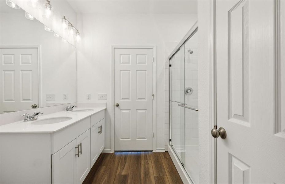 Spacious owner's bathroom with dual vanity and large shower *real home pictured