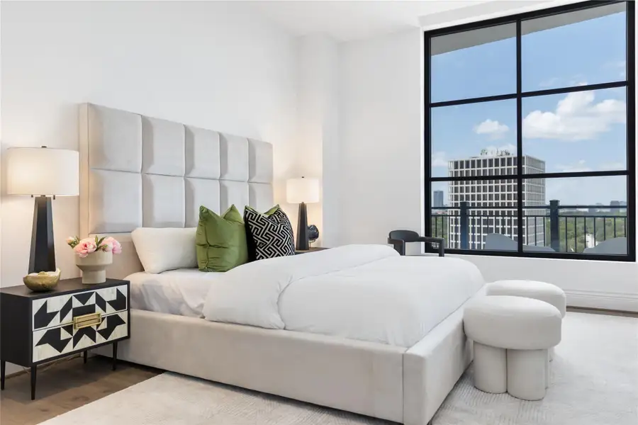 The primary suite offers a serene retreat with expansive windows framing elevated views, filling the space with natural light and creating a bright, peaceful atmosphere.