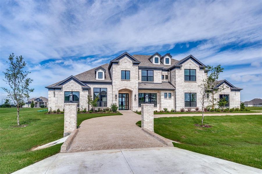 French country inspired facade featuring a front yard