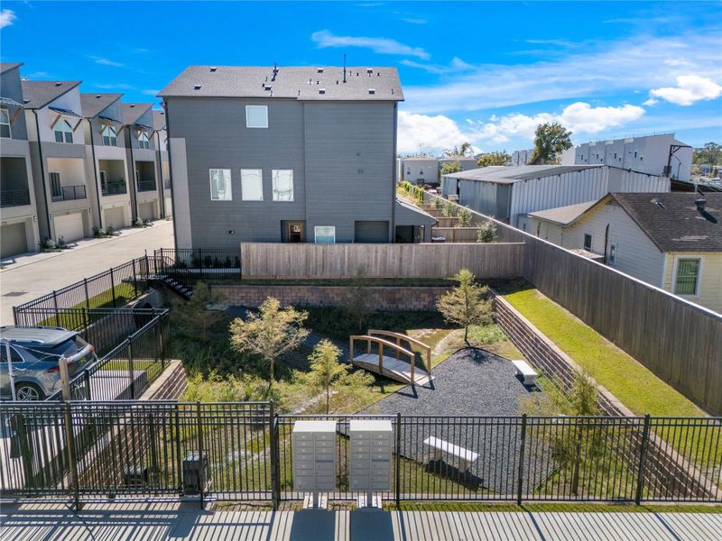 The spacious green space can be used as a dog park or a quiet spot for the community to relax and enjoy nature.