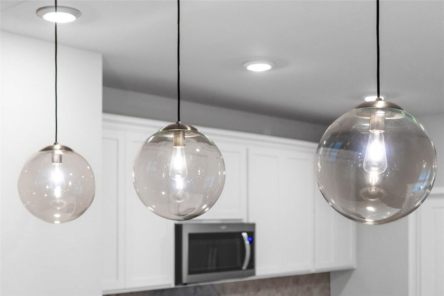 Atwell Pendant Brushed Nickel lights that hang over the kitchen counter.