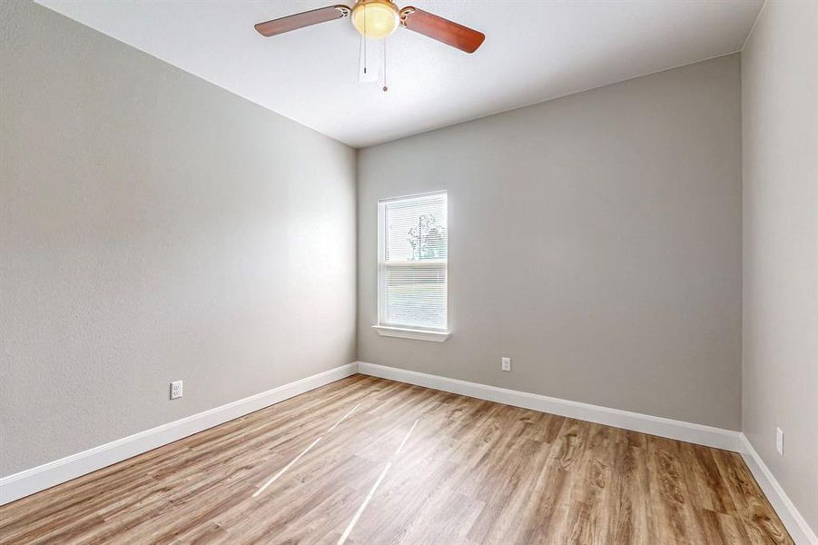 Spare room featuring ceiling fan and wood-type flooring