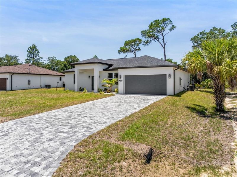Front exterior of a new home in , North Port, FL, highlighting curb appeal (Image 2). Front exterior of a new home in , North Port, FL, highlighting curb appeal (Image 2).