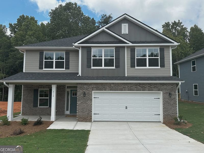 Front exterior of a new home in Canterbury Villas, Carrollton, GA, highlighting curb appeal (Image 1).