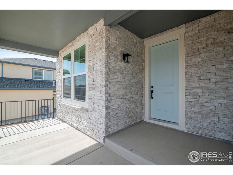 Welcome your guests on the east facing covered front porch with stacked stone detail