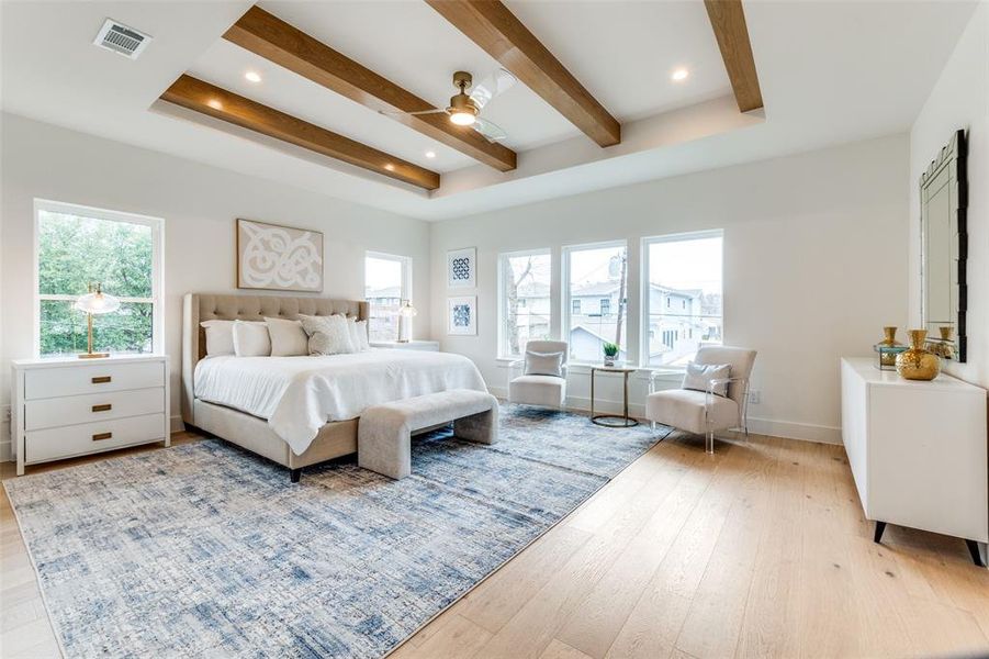 Bedroom featuring multiple windows, ceiling fan, light hardwood / wood-style floors, and beam ceiling