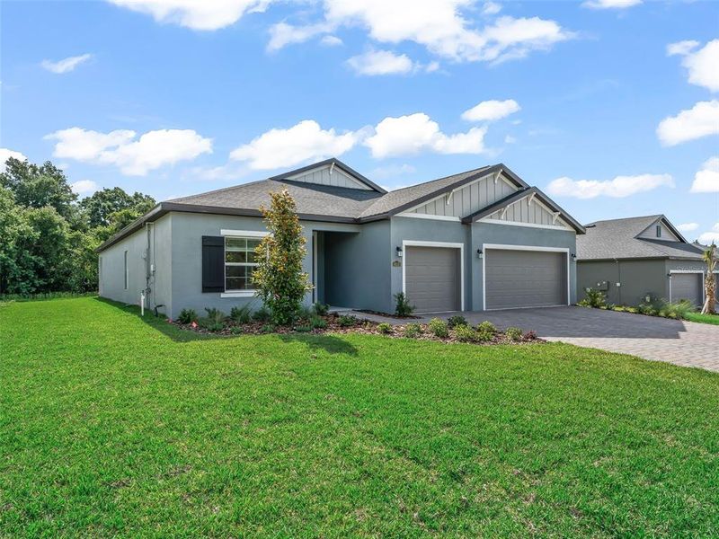 Front exterior of a new home in Juliette Falls, Dunnellon, FL, highlighting curb appeal (Image 25).