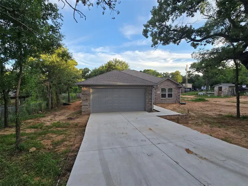 Front exterior of a new home in , Mineral Wells, TX, highlighting curb appeal (Image 1). Front exterior of a new home in , Mineral Wells, TX, highlighting curb appeal (Image 1).