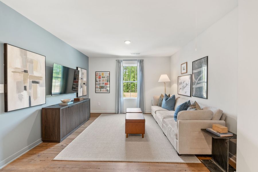 A living room with a couch and a table. A living room with a couch and a table.