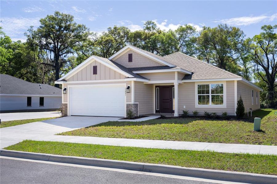 Front exterior of a new home in Briarwood, Alachua, FL, highlighting curb appeal (Image 26).