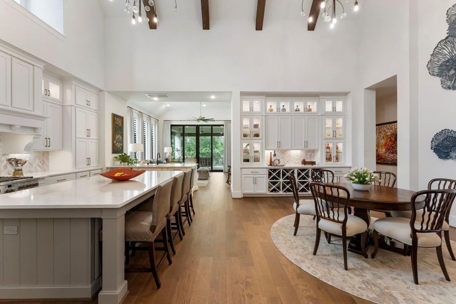 A seamless connection between the kitchen and dining area supports both casual meals and larger gatherings. Custom built-ins add beauty, storage, and architectural character to the open living design.