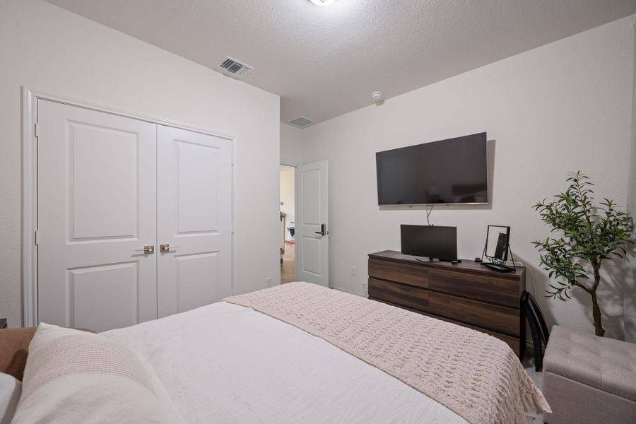 Bedroom with a closet and a textured ceiling