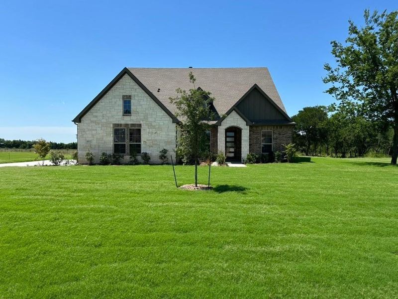 Front exterior of a new home in Fannin Ranch, Leonard, TX, highlighting curb appeal (Image 18).
