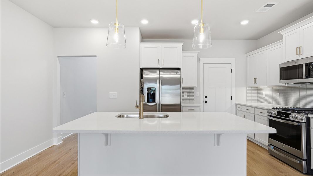 Memorable meals begin in this vibrant kitchen with pendant lighting and a thoughtfully designed island in Anderson, SC Memorable meals begin in this vibrant kitchen with pendant lighting and a thoughtfully designed island in Anderson, SC