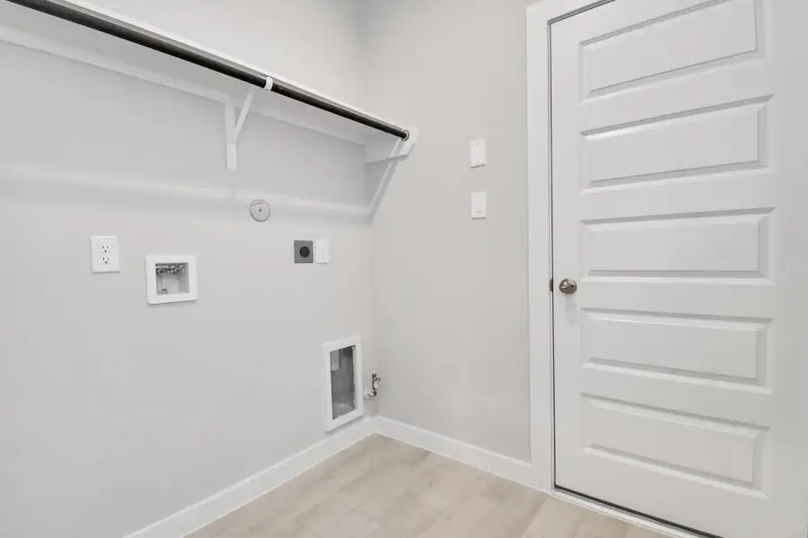 A perfect blend of functionality and comfort. Capture the essence of easy living with a first-floor laundry room, thoughtfully equipped with shelving for effortless organization. Both electric and gas connections available. Sample photo of completed home with similar floor plan. Actual colors and selections may vary. A perfect blend of functionality and comfort. Capture the essence of easy living with a first-floor laundry room, thoughtfully equipped with shelving for effortless organization. Both electric and gas connections available. Sample photo of completed home with similar floor plan. Actual colors and selections may vary.