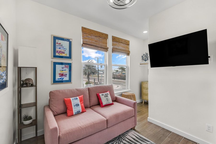 Living area with wood finished floors and recessed lighting Living area with wood finished floors and recessed lighting