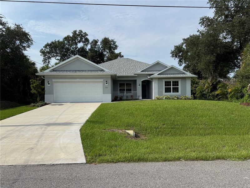 Front exterior of a new home in , North Port, FL, highlighting curb appeal (Image 1). Front exterior of a new home in , North Port, FL, highlighting curb appeal (Image 1).