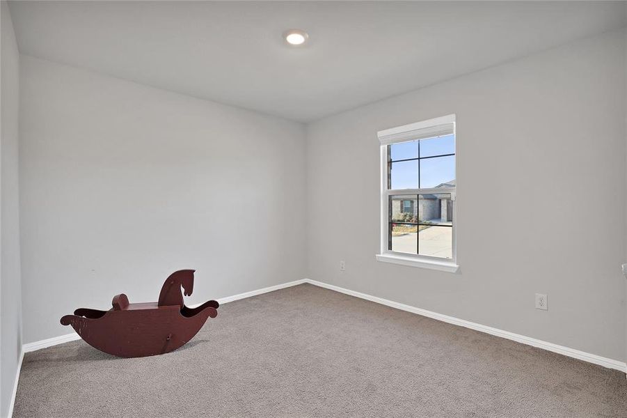 Front bedroom works well as office, playroom, exercise room, or guest space.