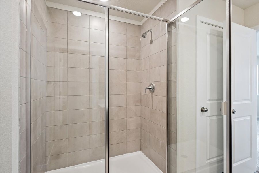 A shower with a glass door.