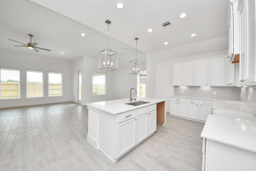 The kitchen is a culinary haven, featuring granite countertops, a tile backsplash, stainless steel appliances, 42” upper cabinets, and undercabinet lighting. The kitchen is a culinary haven, featuring granite countertops, a tile backsplash, stainless steel appliances, 42” upper cabinets, and undercabinet lighting.