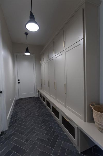 Mudroom with baseboards and brick patterned floors