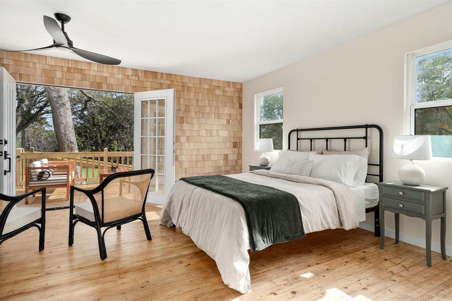 The bedroom suite is stunning; shingle siding accent wall; French doors to the deck.