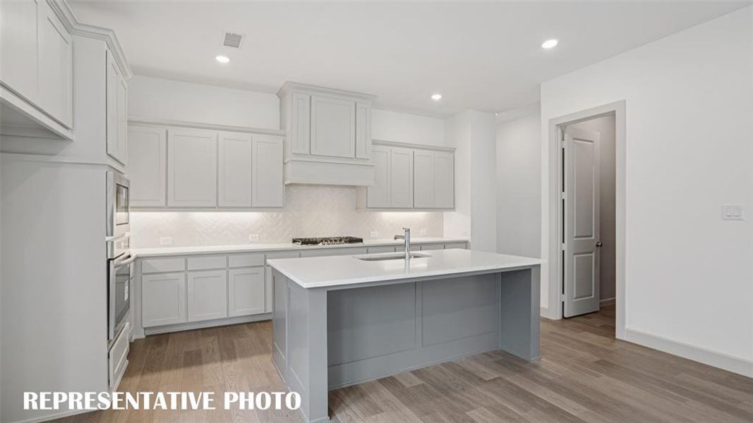 Your new dream home features a spacious kitchen island that is perfect for friends and family to gather round.  REPRESENTATIVE PHOTO