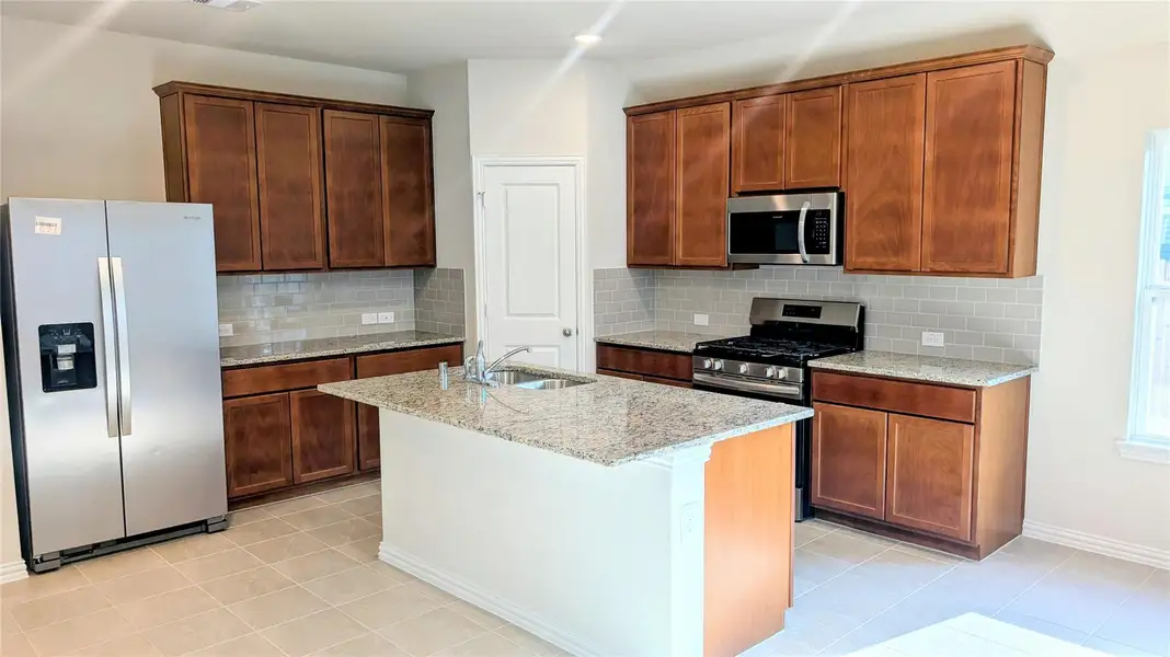 Kitchen with brand new refrigerator