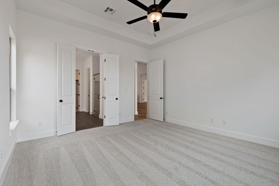Primary Bedroom with elevated ceiling Primary Bedroom with elevated ceiling