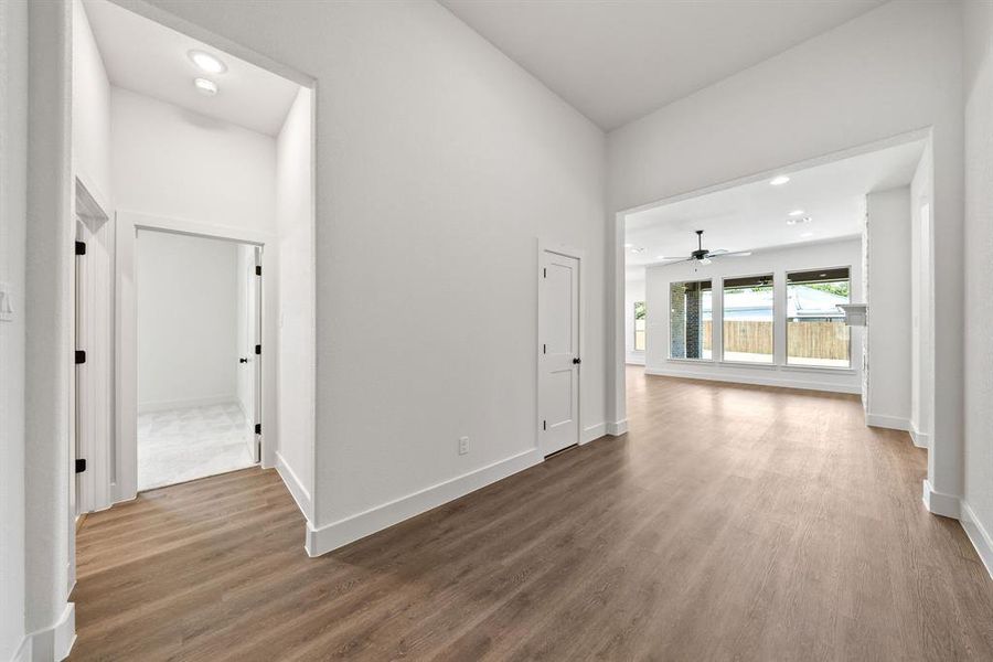 Hallway with recessed lighting and wood finished floors