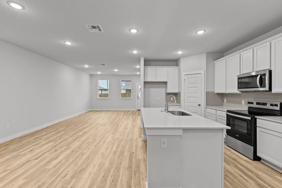 A kitchen with white cabinets. A kitchen with white cabinets.