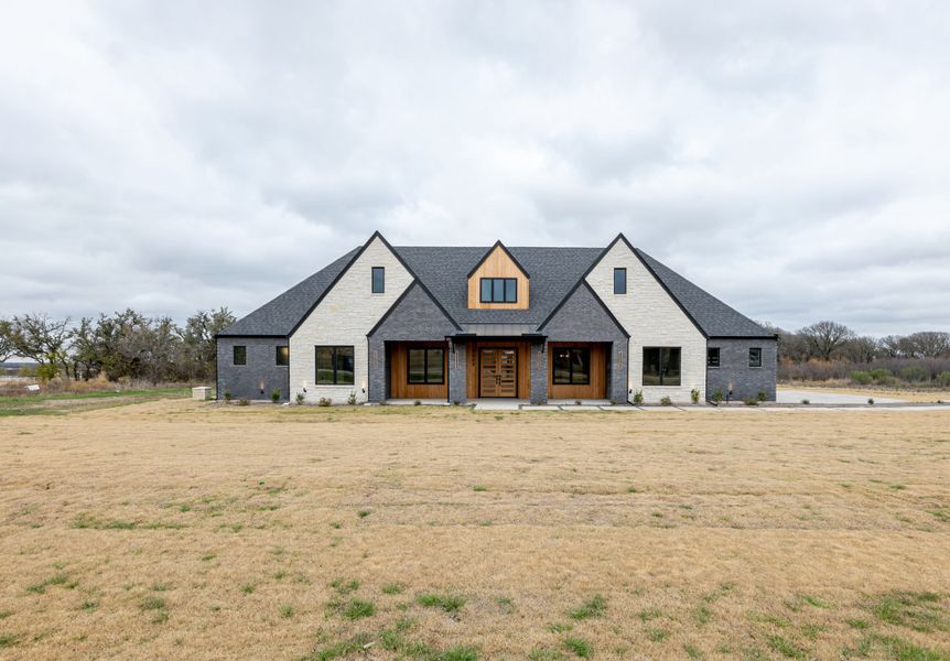 Front exterior of a new home in Summit Ranch, Aledo, TX, highlighting curb appeal (Image 34). Front exterior of a new home in Summit Ranch, Aledo, TX, highlighting curb appeal (Image 34).