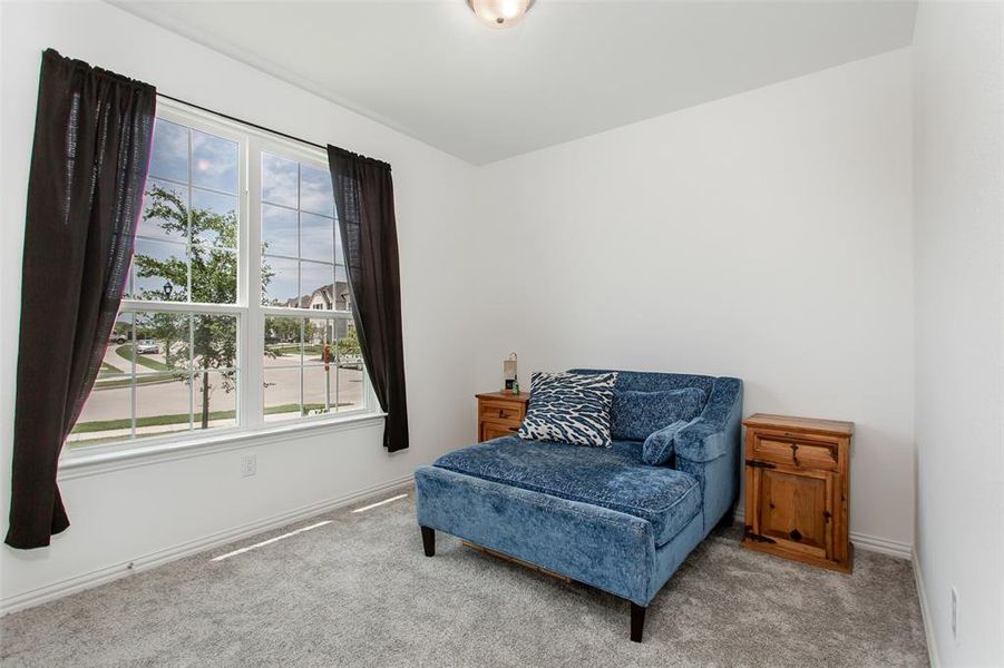 Living area featuring healthy amount of natural light and carpet flooring