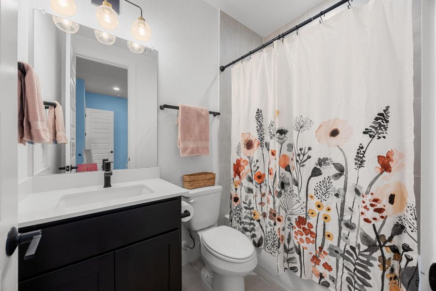 Bathroom with vanity and a shower with curtain
