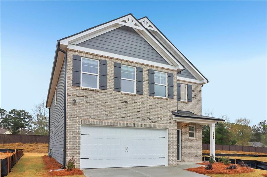 Front exterior of a new home in Abbotts Crossing, Conyers, GA, highlighting curb appeal (Image 26).