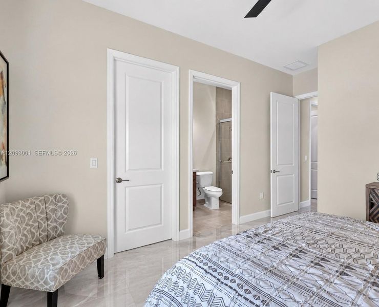 Polished tile flooring, two-panel interior doors with brushed nickel hardware, and recessed ceiling lighting Polished tile flooring, two-panel interior doors with brushed nickel hardware, and recessed ceiling lighting