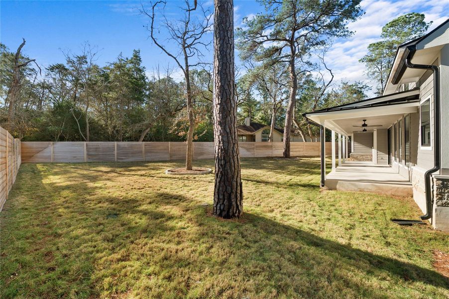 View of yard featuring ceiling fan and a patio