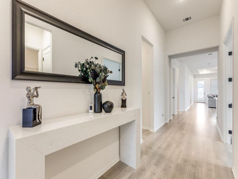 Inside, it’s inviting and calm with high ceilings, 8-foot doors, and wide-plank wood-look flooring through the main living areas.