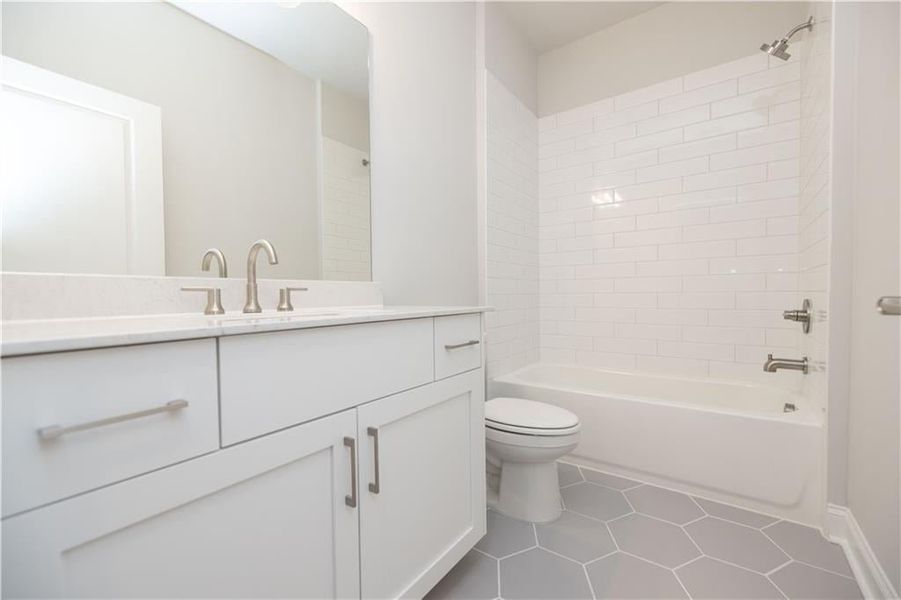 A full bathroom is located in the hallway across from bedroom two and three. *Please note photos shown are of the Ellington plan but not of the actual home.