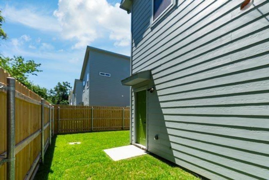 View of side of property with a fenced backyard