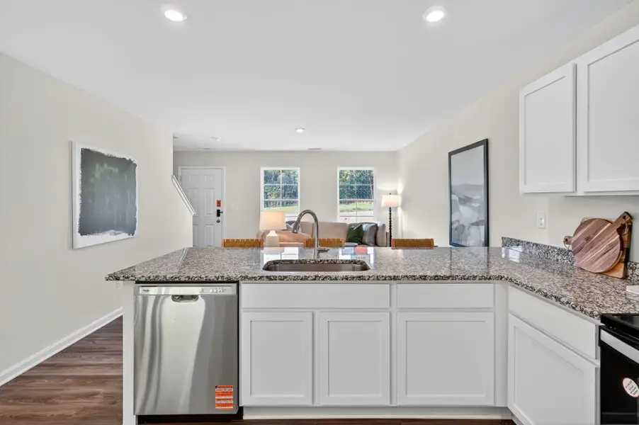A kitchen with white cabinets.