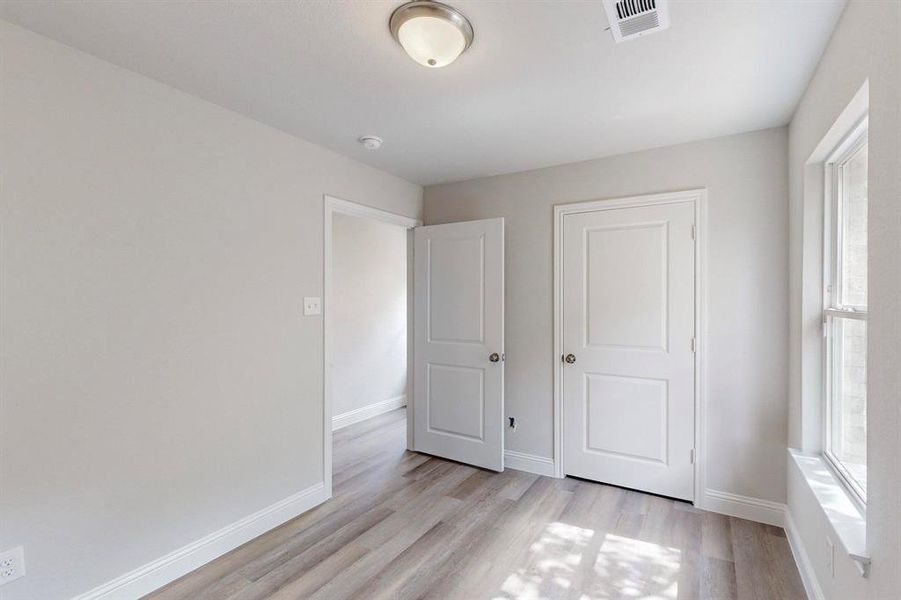 Unfurnished bedroom featuring light hardwood / wood-style floors