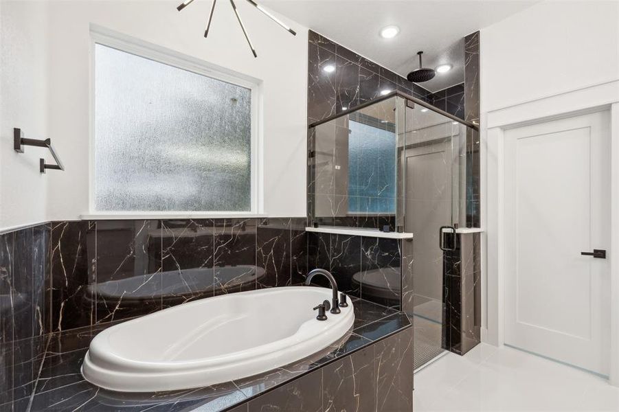 Bathroom featuring tile patterned floors and plus walk in shower