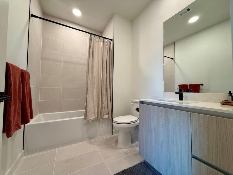 A well-appointed bathroom with a spacious vanity and a combination tub and shower.