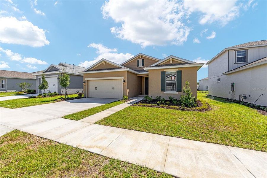 Front exterior of a new home in Calesa Township, Ocala, FL, highlighting curb appeal (Image 20).