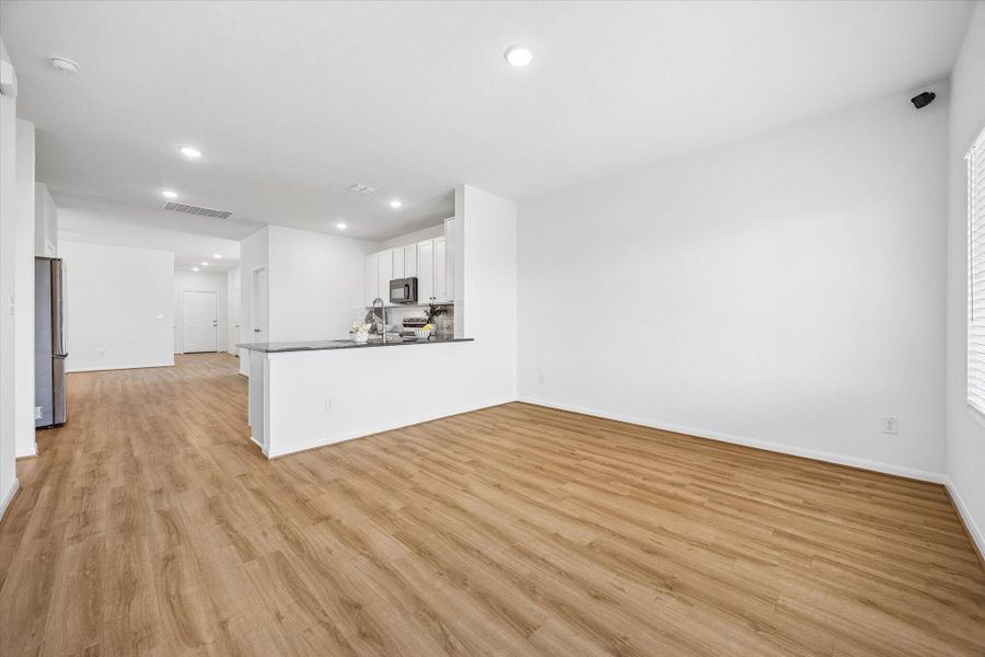Unfurnished living room with light wood-type flooring and recessed lighting